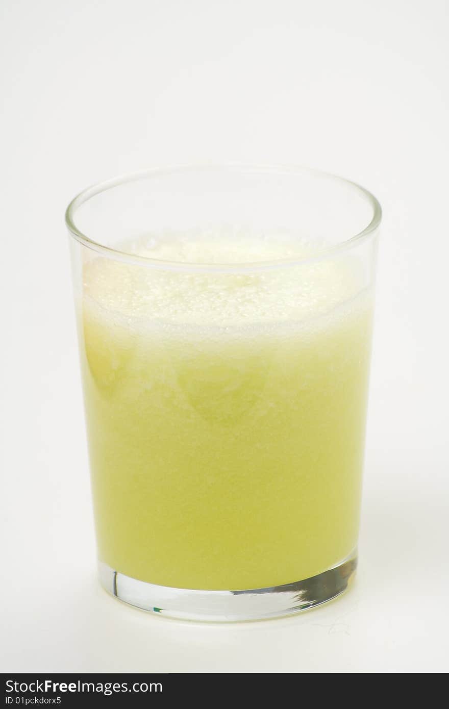 A delicious melon milkshake isolated over white. A delicious melon milkshake isolated over white