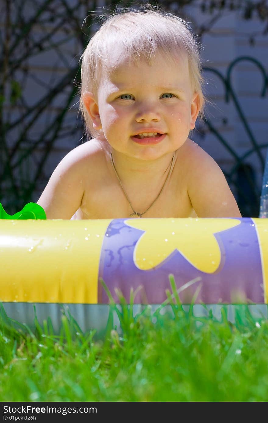 Funny little girl in yellow pool