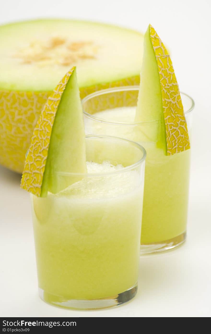 A delicious melon milkshake isolated over white. A delicious melon milkshake isolated over white