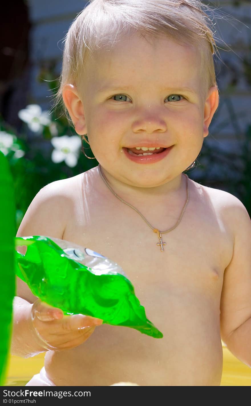 Happy little girl in yellow pool