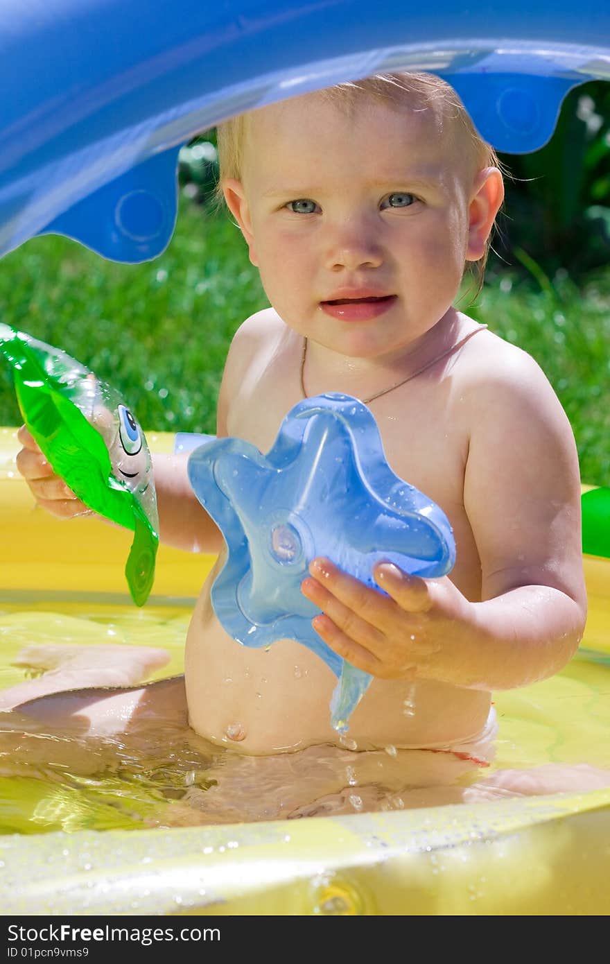 Little girl in yellow pool