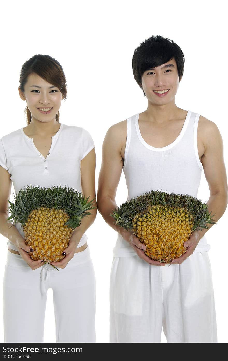 Happy couple showing a healthy fruit. Happy couple showing a healthy fruit