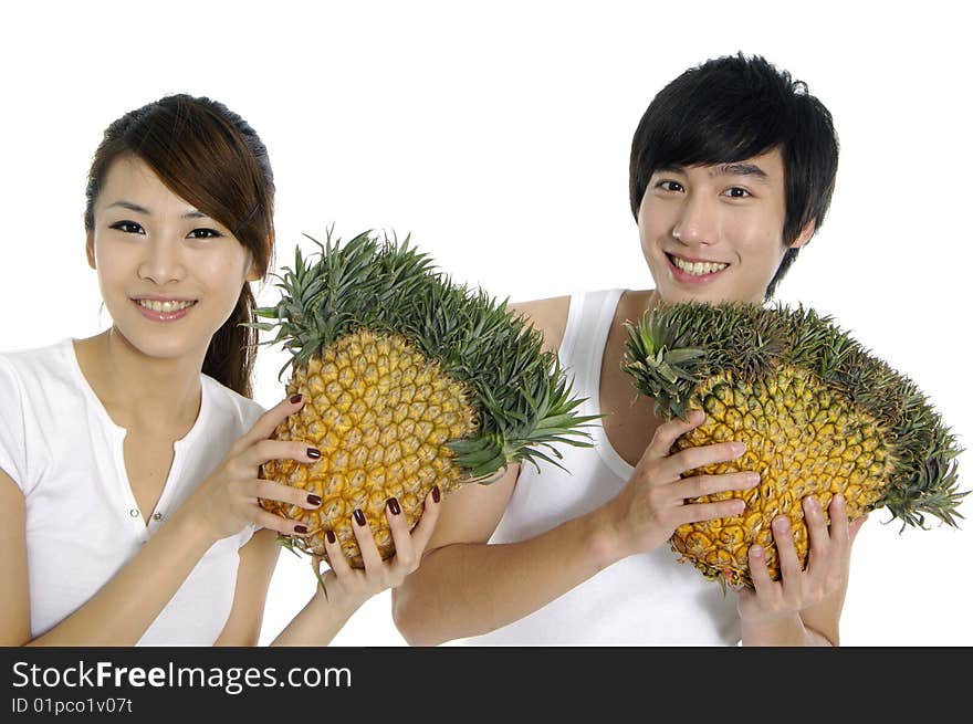 Happy couple showing a healthy fruit. Happy couple showing a healthy fruit