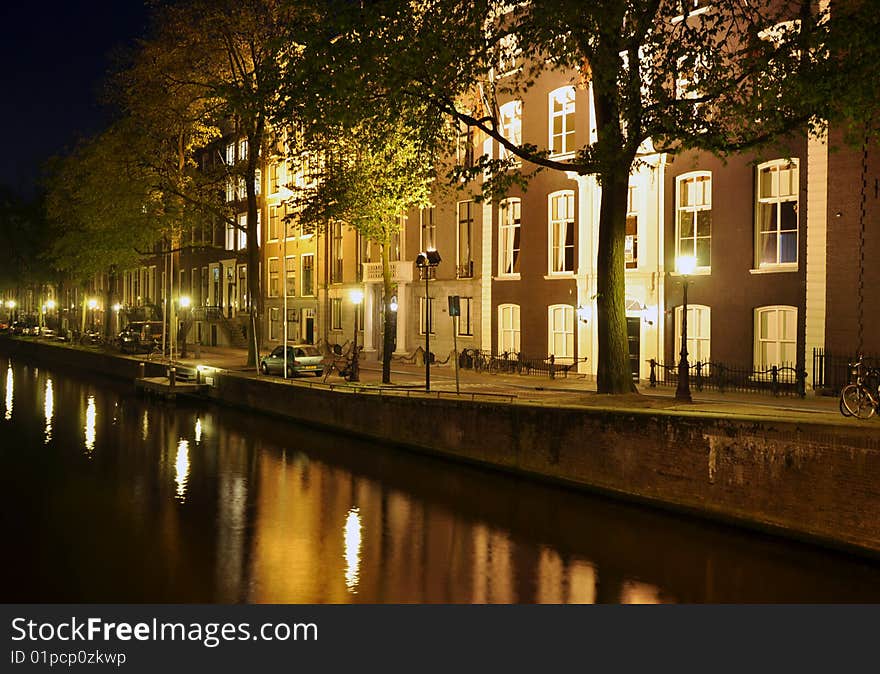 Street scene at night along a canal in Amsterdam. Street scene at night along a canal in Amsterdam