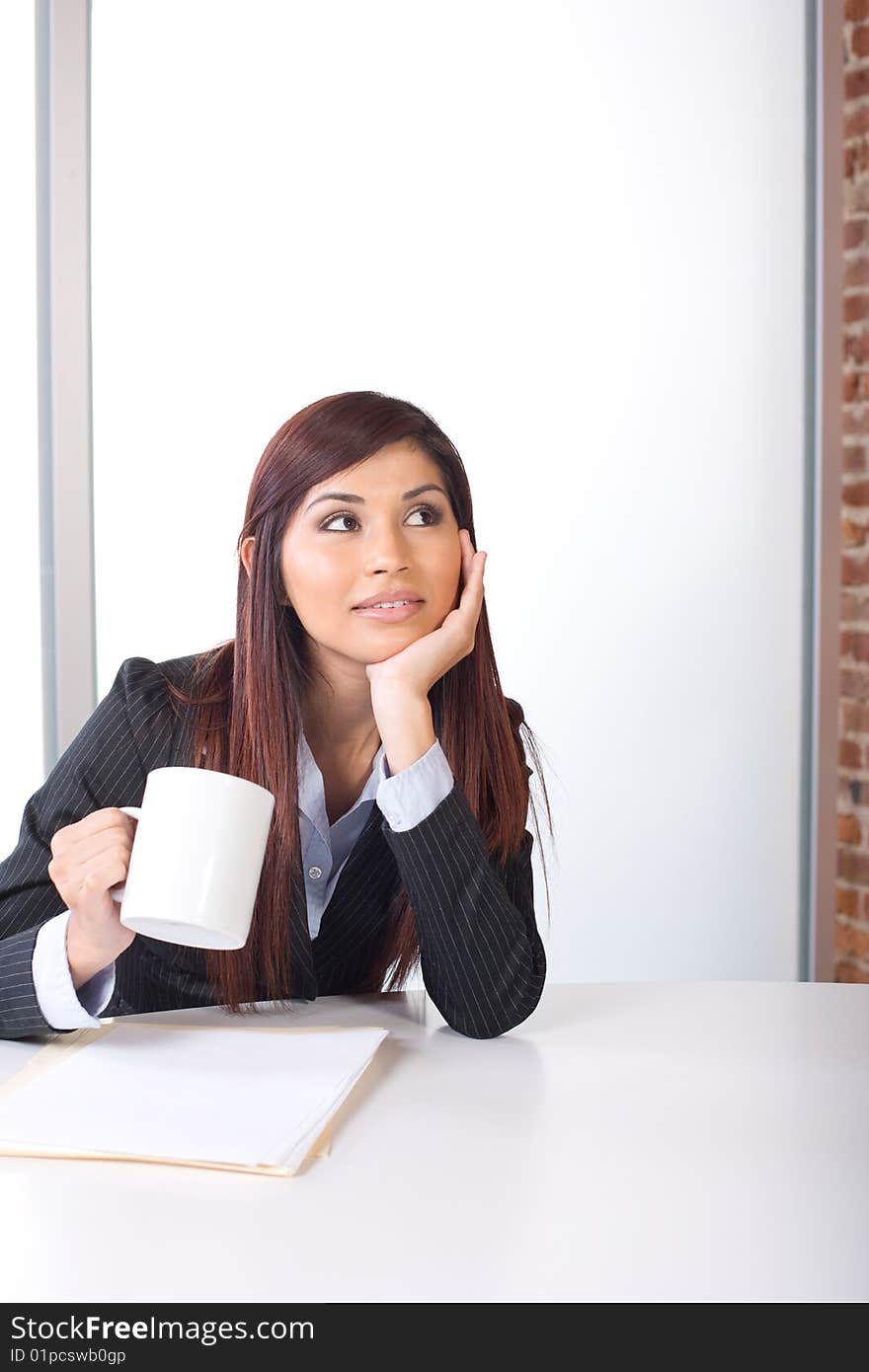 Business woman thinking in a modern office