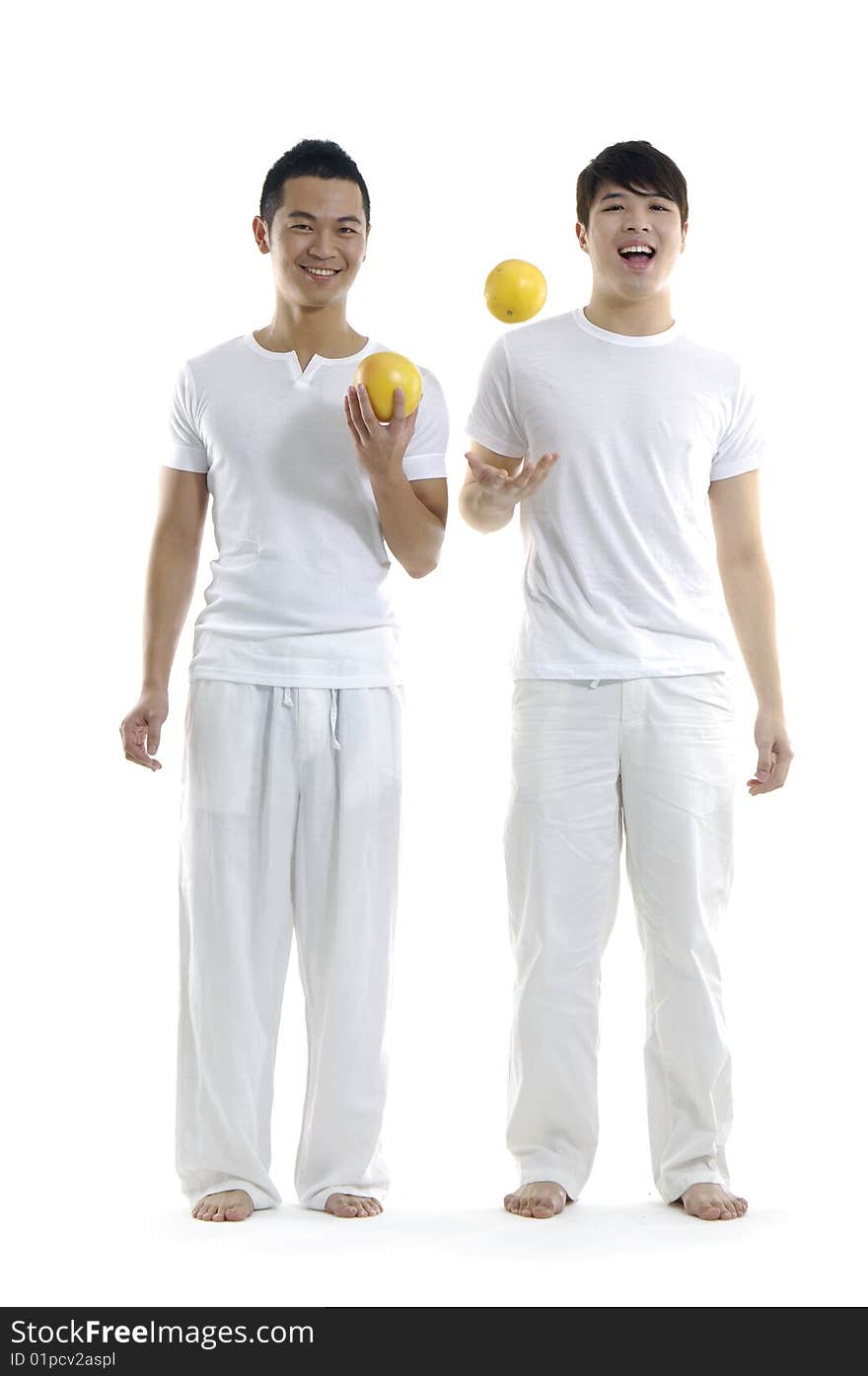 Young man holding and tossing grapefruit. Young man holding and tossing grapefruit