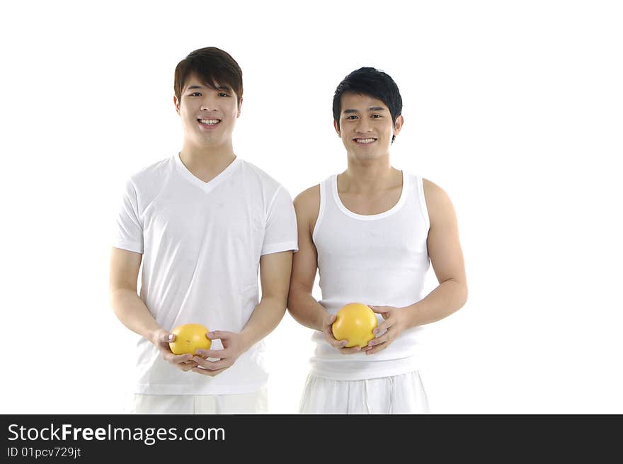 Young man holding and tossing grapefruit. Young man holding and tossing grapefruit