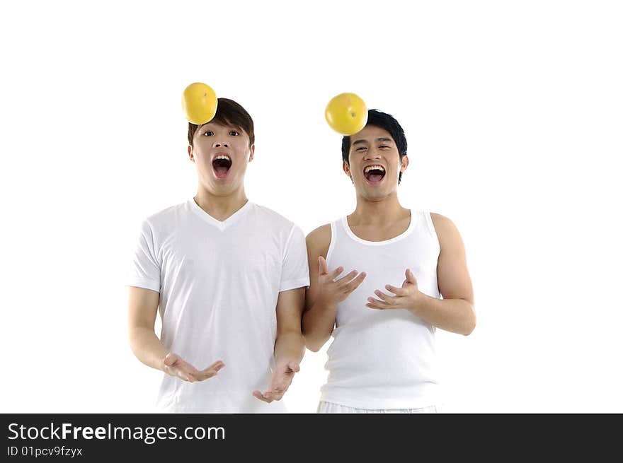 Couple young man tossing grapefruit. Couple young man tossing grapefruit