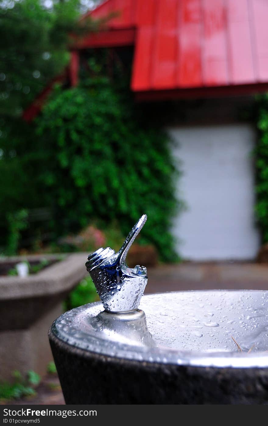 A drinking fountain covered with water drops