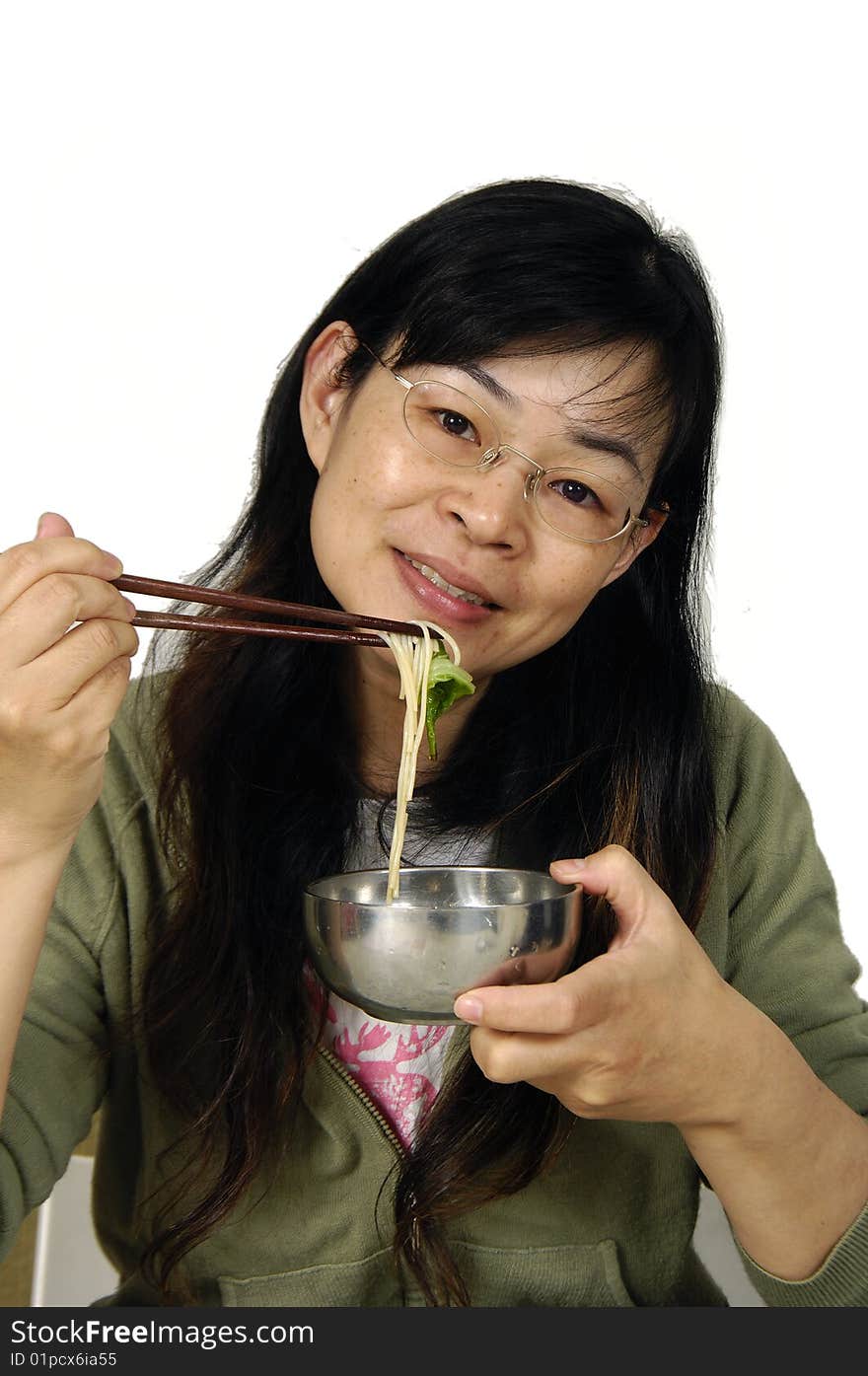 Young happy woman with plate of vermicelli at kitchen. Young happy woman with plate of vermicelli at kitchen