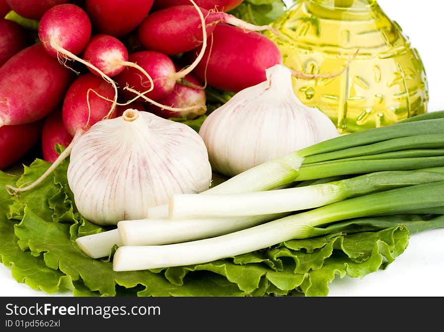 Green vegetables and  bottle of oil