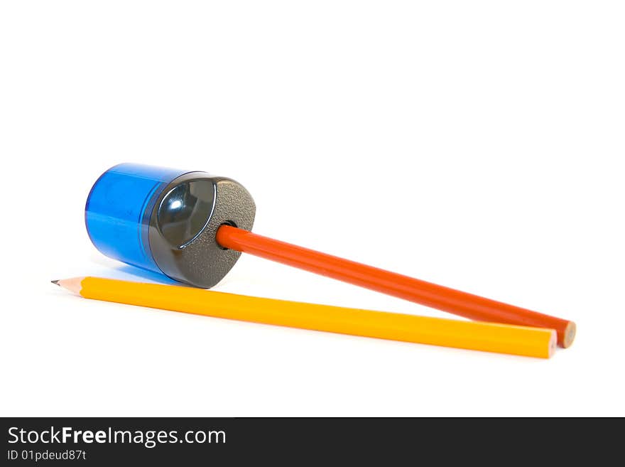 Orange and yellow pencils with sharpener on a white background. Orange and yellow pencils with sharpener on a white background