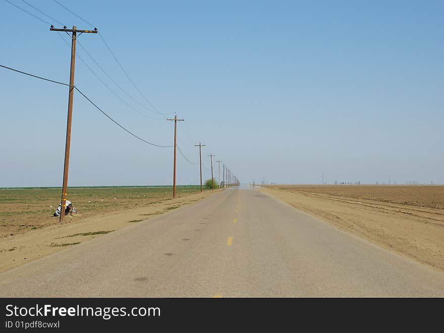 Long straight road in american farmland