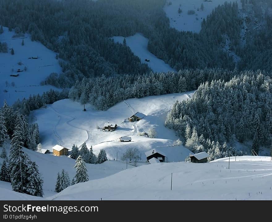 The mountain village in Alps, Switzerland, shined with a ray of light.