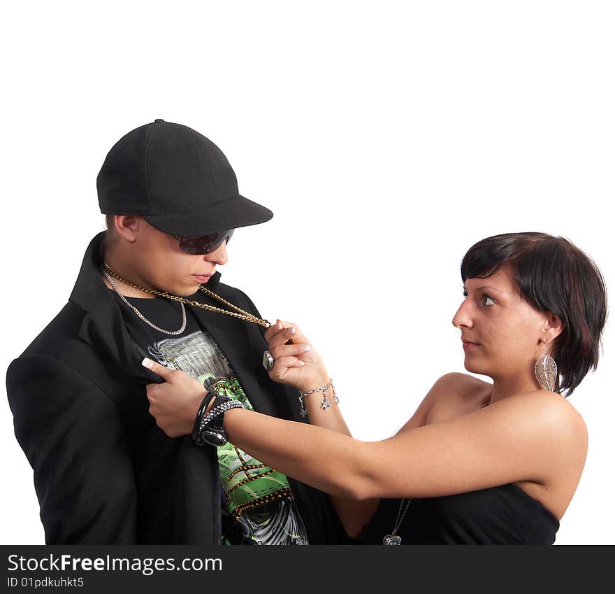 Young couple in love is about to kiss. The woman is pulling the man closer with his necklace. Isolated over white. Young couple in love is about to kiss. The woman is pulling the man closer with his necklace. Isolated over white.