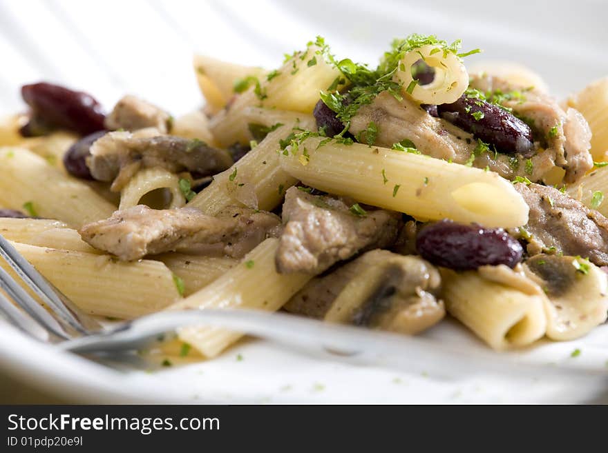 Penne with pork pieces and champignons. Penne with pork pieces and champignons