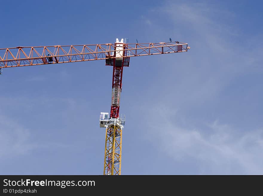 Two construction cranes on a blue sky