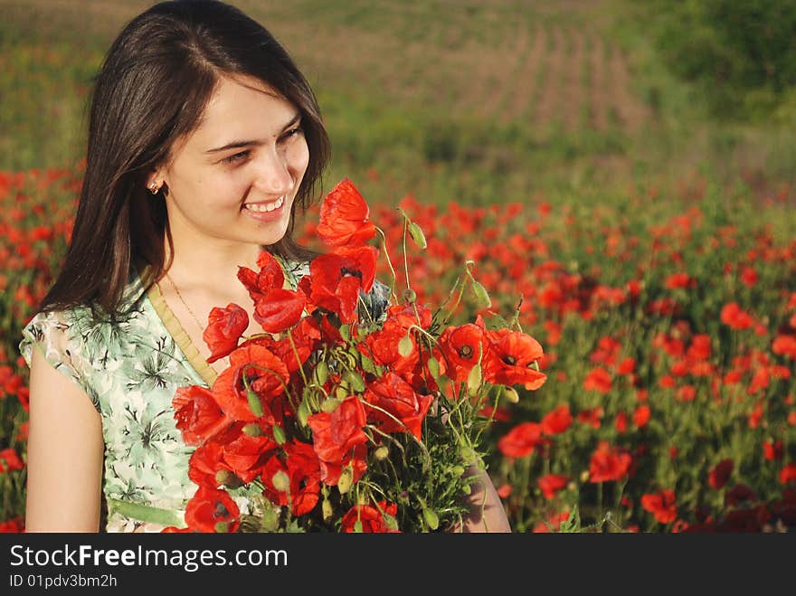 Girl on a red poppies field