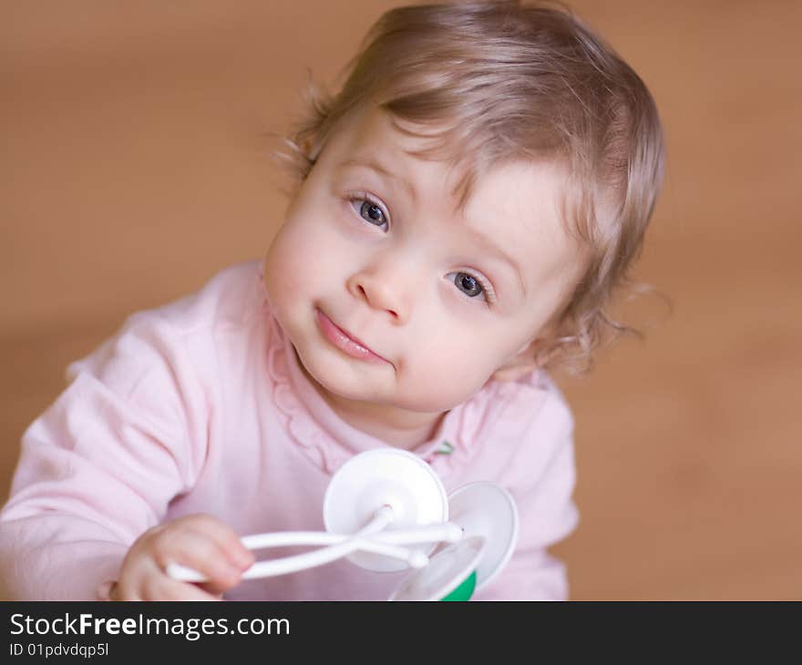 Little girl playing with rattle - shallow DOF