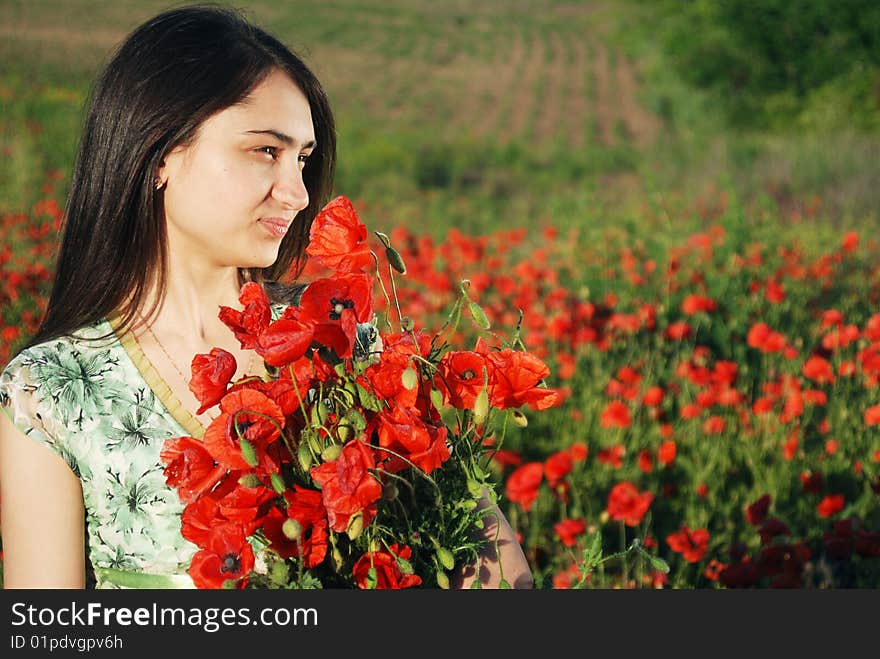 Girl on a red poppies field