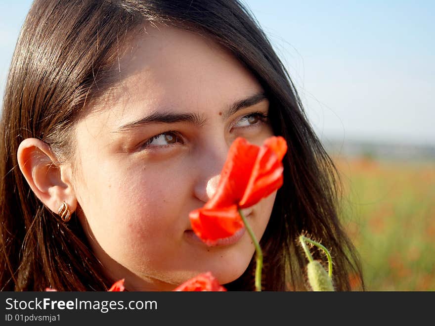 Girl on a red poppies field