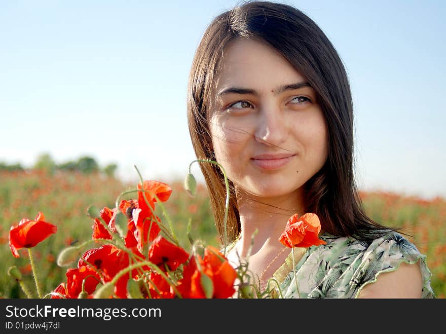 Girl on a red poppies field