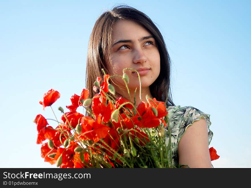 Girl on a red poppies field