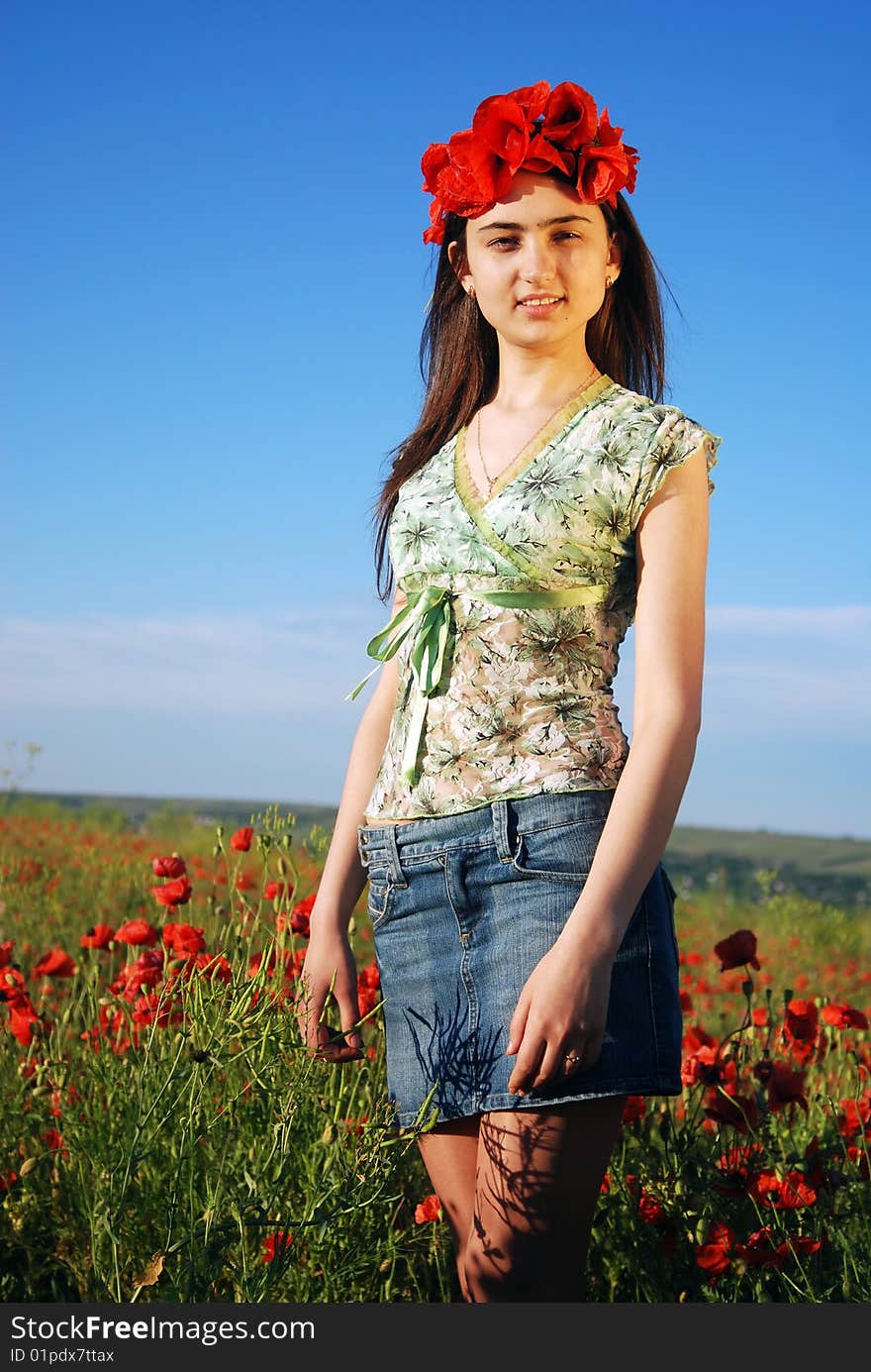 Girl on a red poppies field