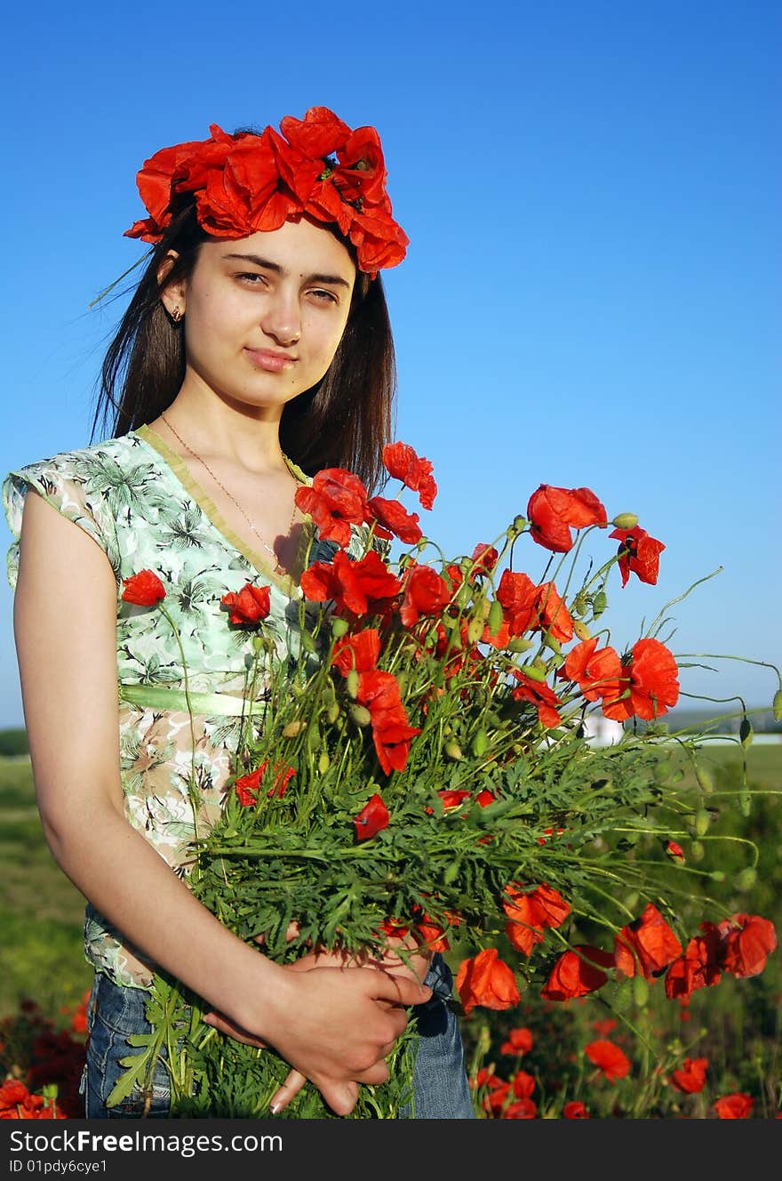 Girl on a red poppies field