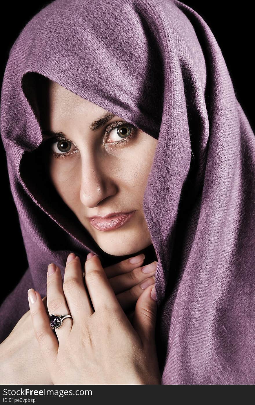 Beauty portrait of a young beautiful woman with a shawl