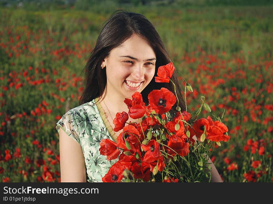 Girl on a red poppies field