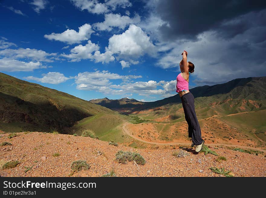 The girl jumping in top in mountains