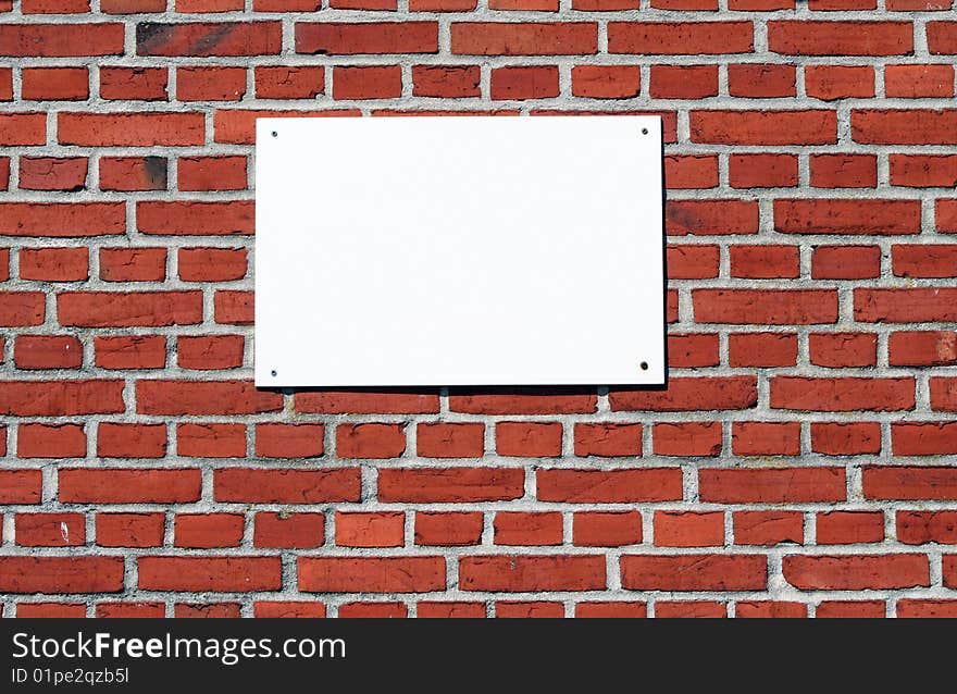 Blank white sign on a brick wall. Blank white sign on a brick wall