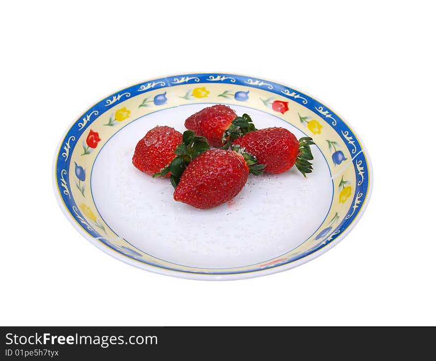 Full Front view of four fresh ripe strawberries sprinkled with course white sugar on colorful flower pattern decorated dish. Full Front view of four fresh ripe strawberries sprinkled with course white sugar on colorful flower pattern decorated dish.