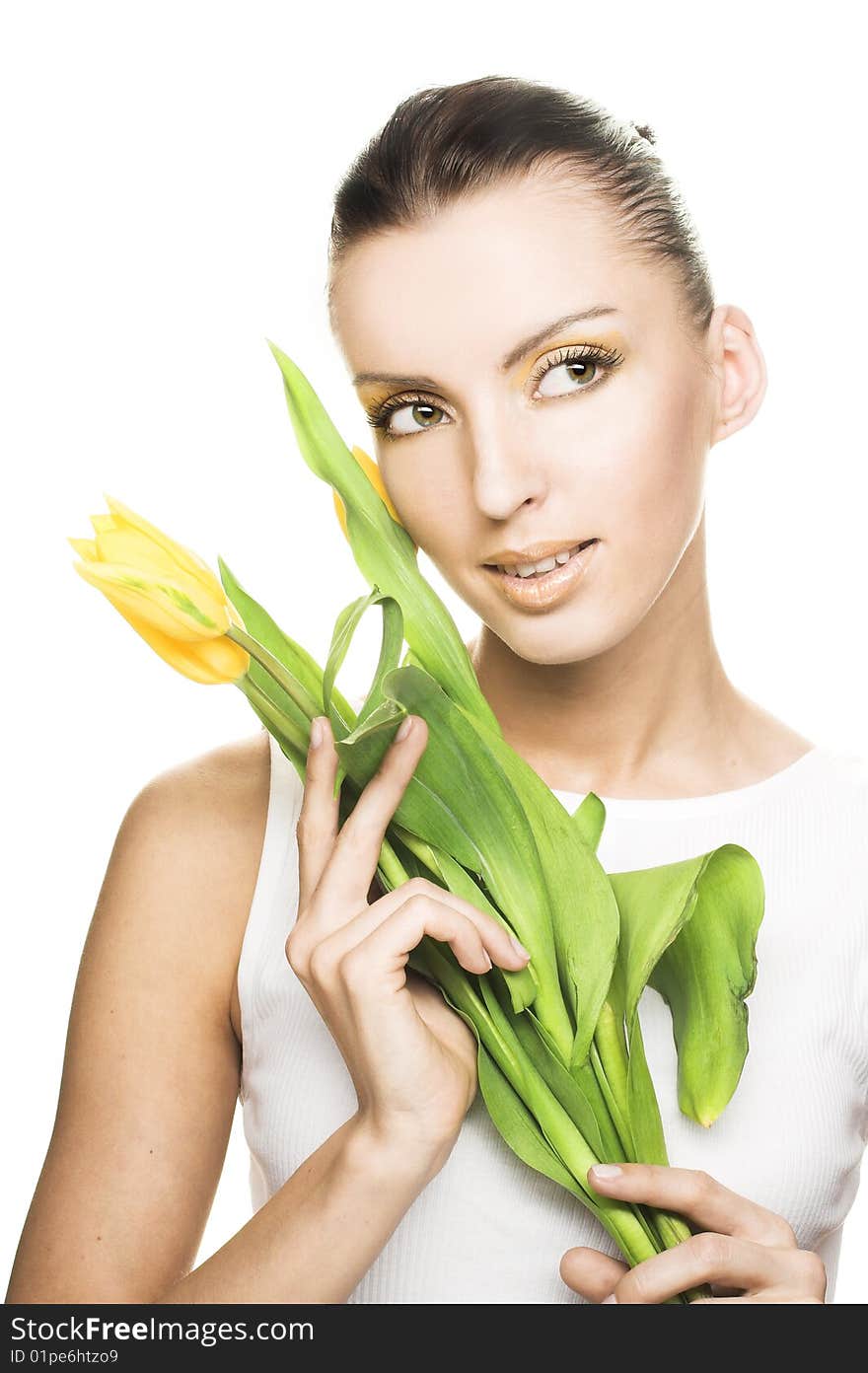 Portrait of young woman with yellow tulips