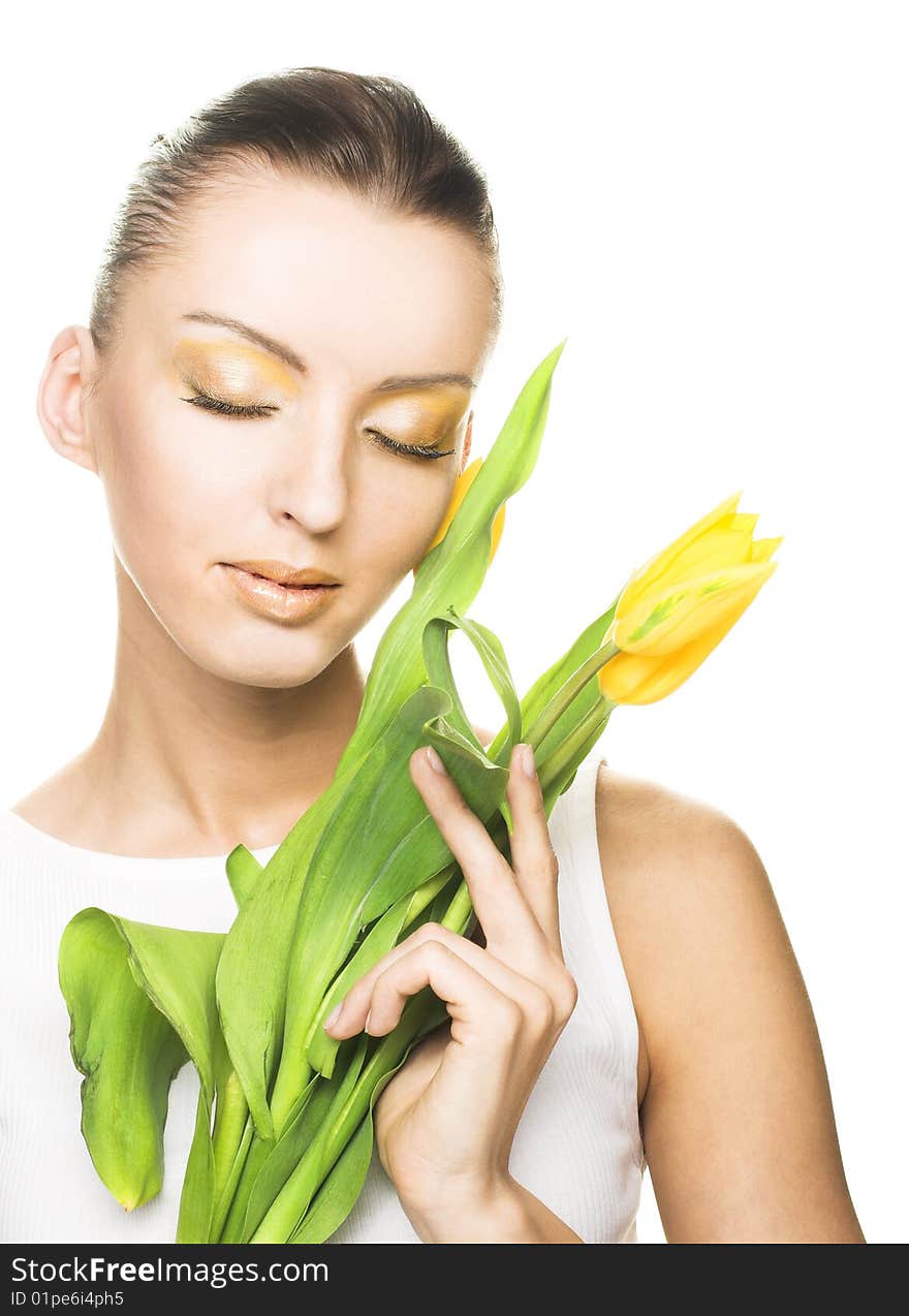 Portrait of young woman with yellow tulips