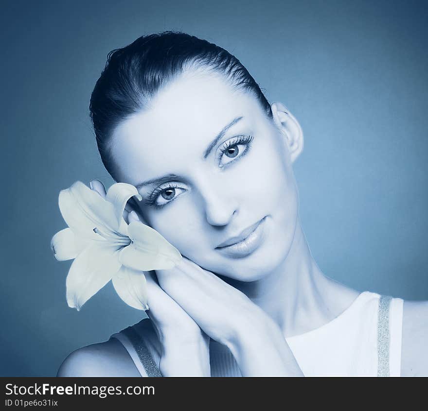 Portrait of young woman with yellow flowers in cold tones. Portrait of young woman with yellow flowers in cold tones