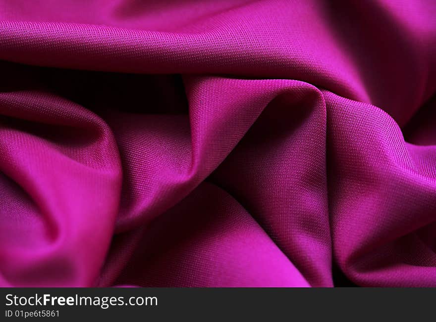 The monocolor purple fabric. Bright background.