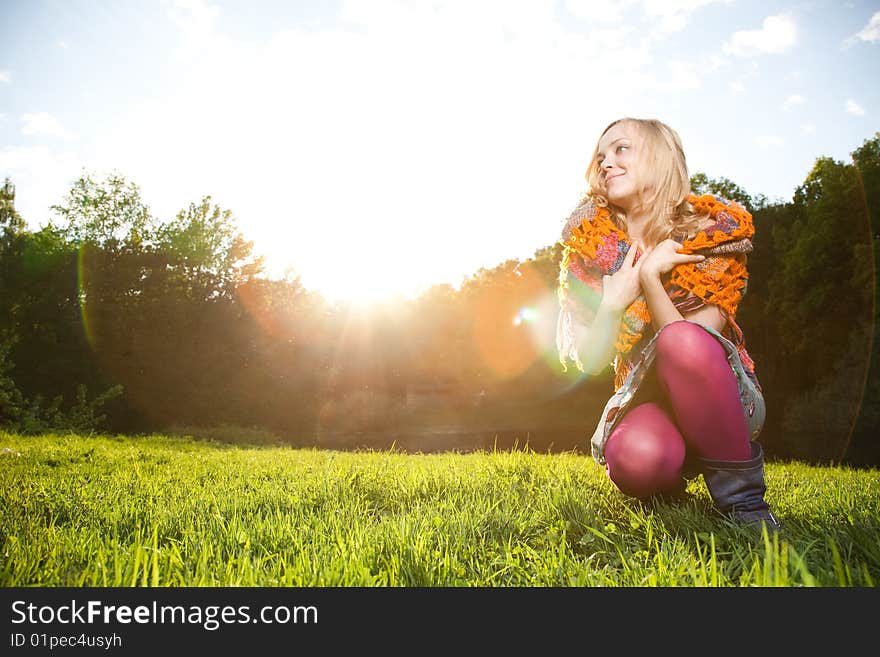 Beauty Woman Sitting On The Green Grass