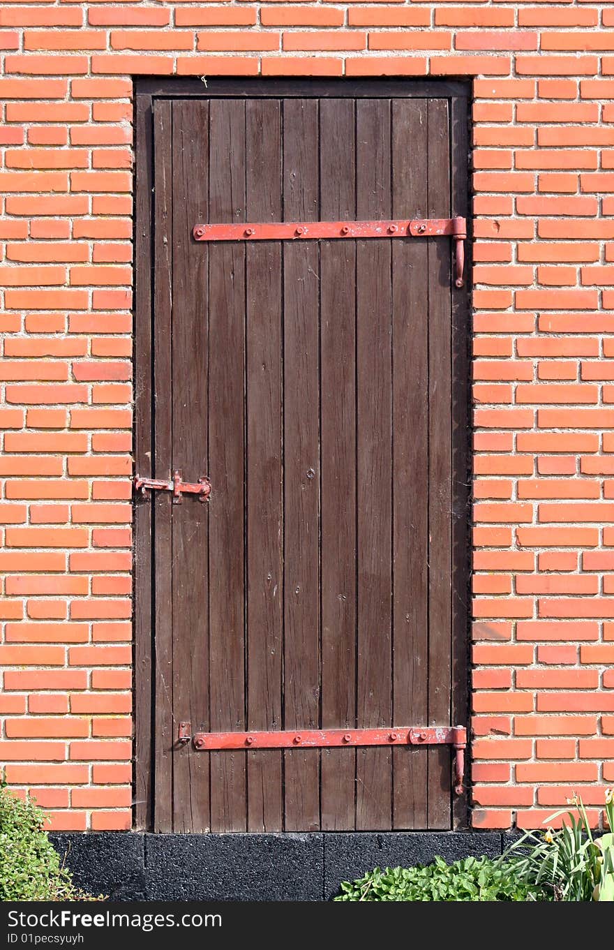 Old wooden door in a red brick house