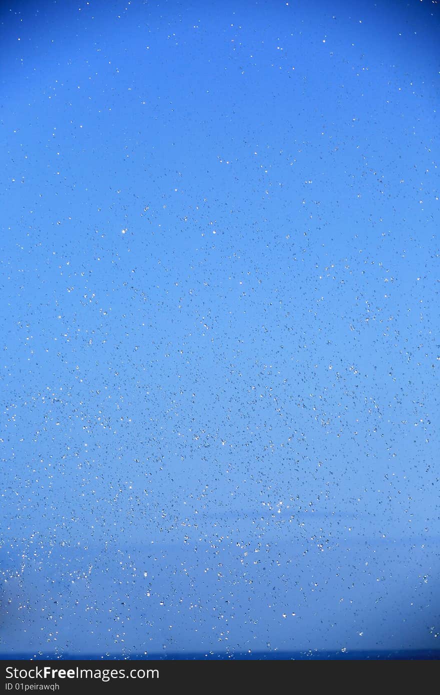 Drops in the air on blue background