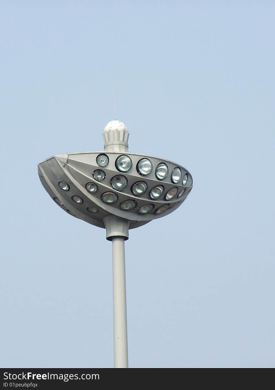 Stadium lights against a clear blue sky background