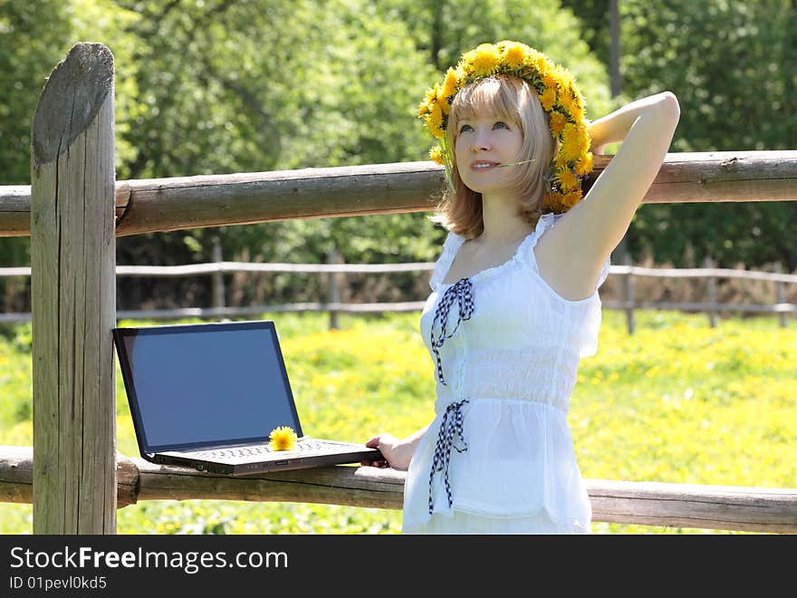 The girl with the computer on the nature. The girl with the computer on the nature