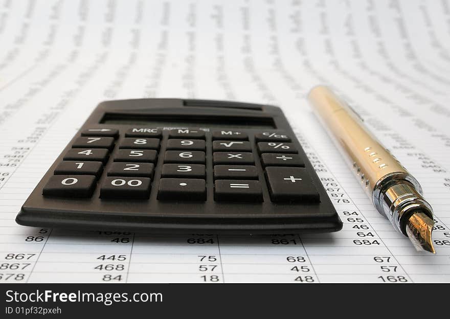 Calculator and pen on a white background. Calculator and pen on a white background