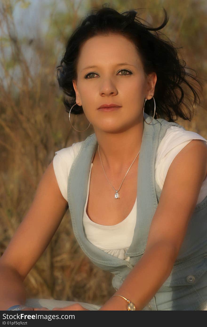 A young beautiful woman sitting outside