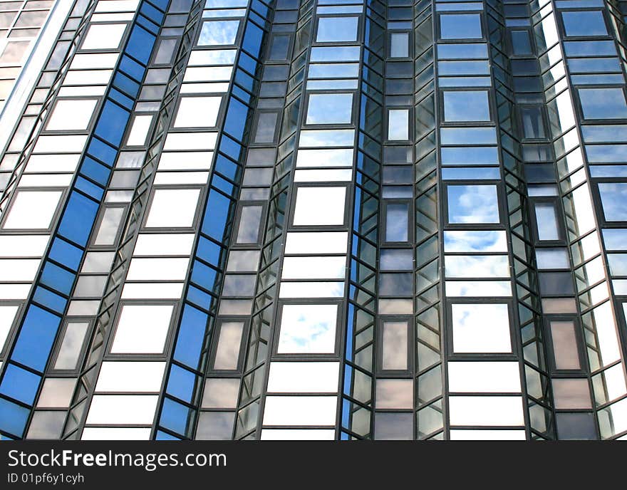 High office building with clouds reflection on it.