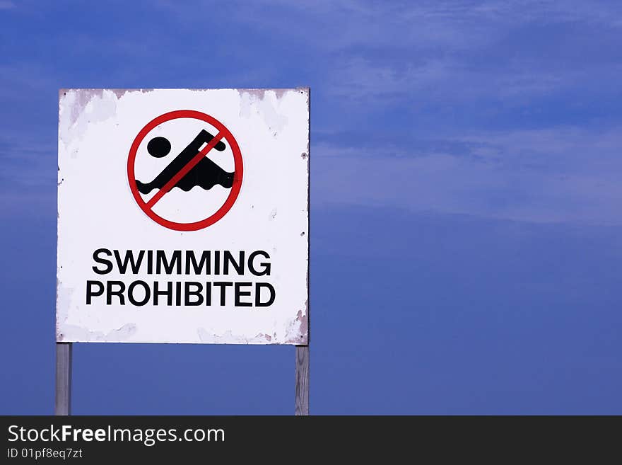 Swimming prohibited sign with blue background. Swimming prohibited sign with blue background