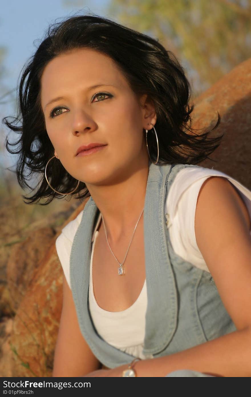 A young beautiful woman sitting outside