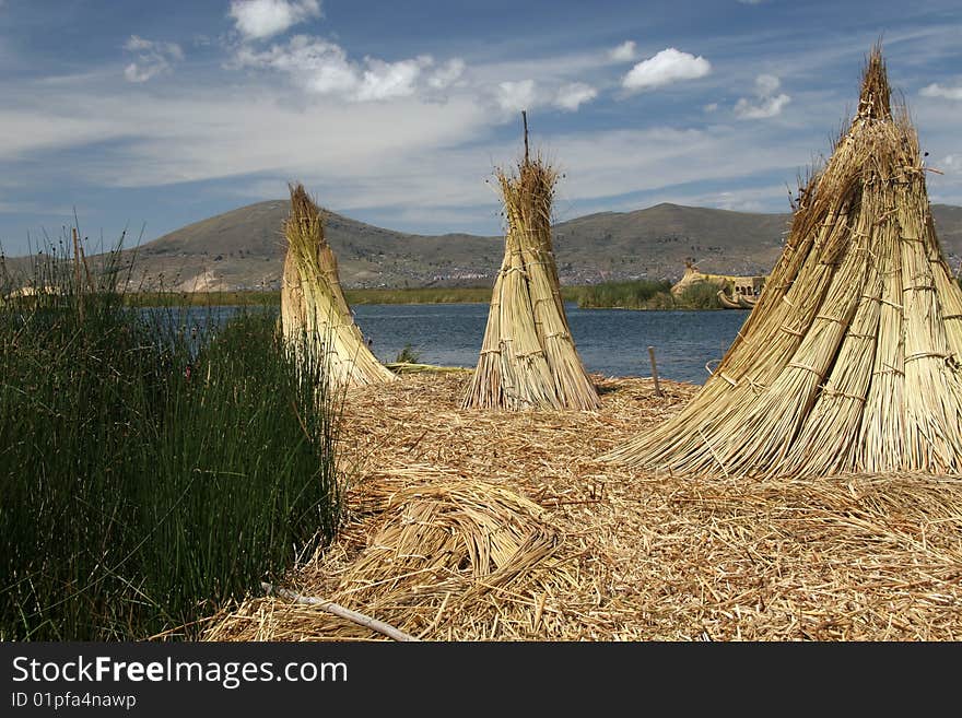 Stacks of reed on a floating island in lago de Titicaca in Peru