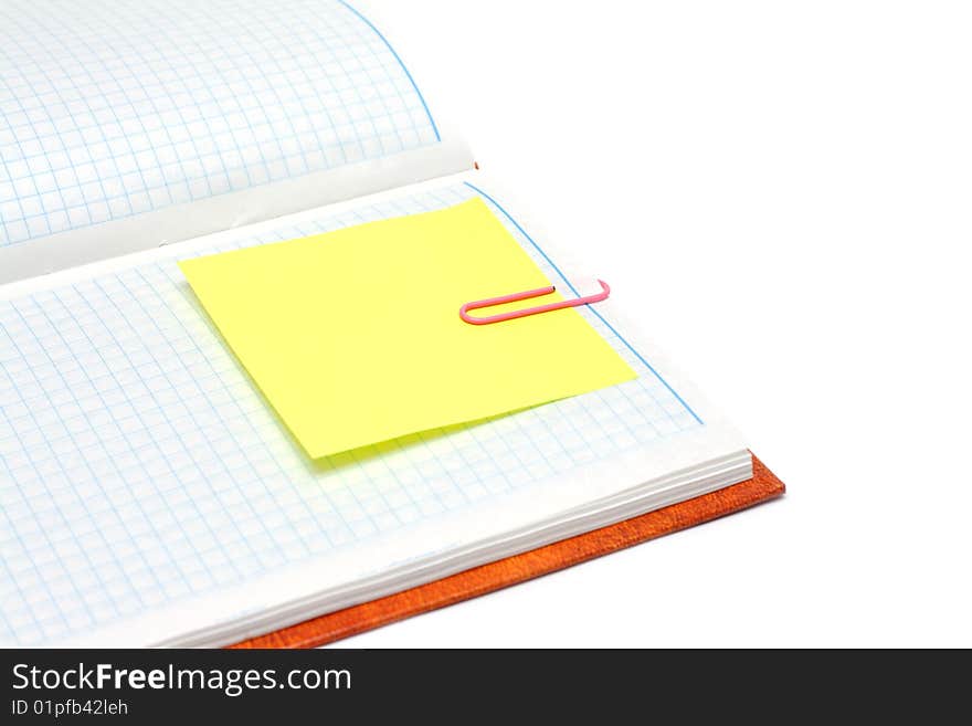 Note pad with plaid paper, yellow bookmark and rose staple